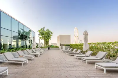 a row of chairs and umbrellas on a building at GuestReady - Above the clouds in Dubai Marina in Dubai