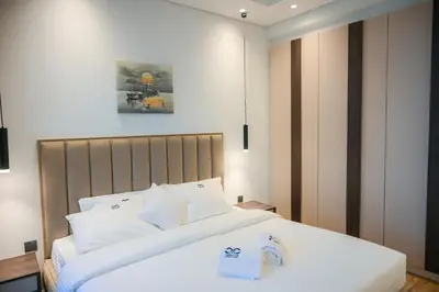 a bedroom with a large bed with white sheets at Luxurious New 1BR Apt Prime Jumeirah Garden City in Dubai