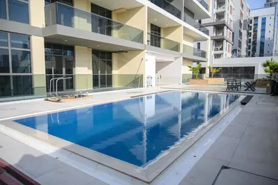 a swimming pool in front of a building at Super Luxurious! New 2BR in Jumeirah Garden City in Dubai