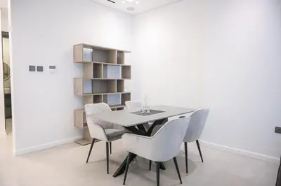 a dining room with a table and chairs at Super Luxurious! New 2BR in Jumeirah Garden City in Dubai