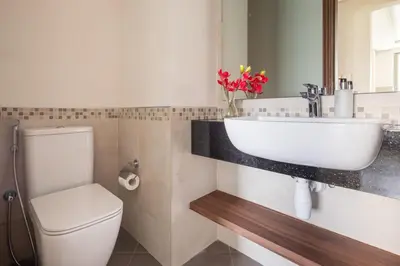 a bathroom with a white sink and a toilet at Frank Porter - Eleganz by Danube in Dubai