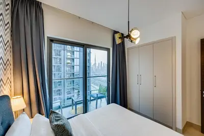 a bedroom with a bed and a large window at Sobha Creek Vistas, Sobha Hartland, MBR City, Dubai in Dubai