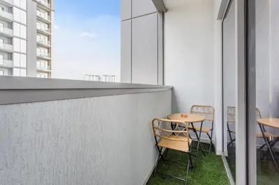 a balcony with chairs and tables on a building at STAY BY LATINEM Luxury 1BR Holiday Home CV A1507 near Burj Khalifa in Dubai
