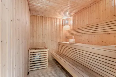 a sauna with wooden walls and wooden shelves at STAY BY LATINEM Luxury 1BR Holiday Home CV A1507 near Burj Khalifa in Dubai