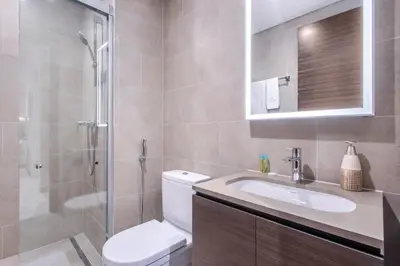 a bathroom with a toilet and a sink and a shower at STAY BY LATINEM Luxury 1BR Holiday Home CV A1507 near Burj Khalifa in Dubai