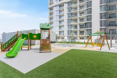 a playground in front of a tall building at STAY BY LATINEM Luxury 1BR Holiday Home CV A1507 near Burj Khalifa in Dubai