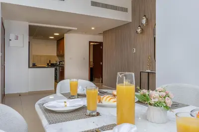 a table with two glasses of orange juice on it at Amazing Seaview Prime Location Upgraded in Dubai