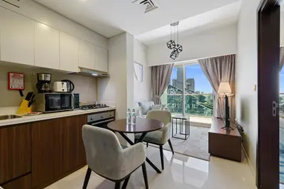 a kitchen and dining room with a table and chairs at 1BR near Dubai Mall 10 Min walking distance in Dubai