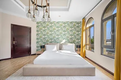 a bedroom with a large white bed in a room at Beachfront Dubai Villa for 10 Guests with Full Kitchen & View in Dubai