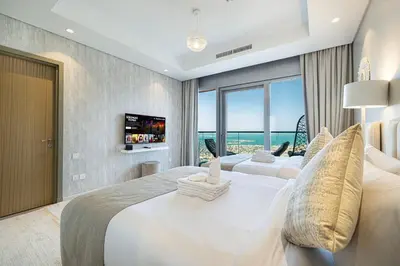 a bedroom with two beds and a large window at Highest infinity Pool in Downtown Dubai in Dubai