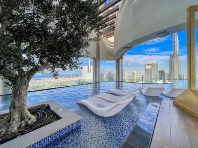 a swimming pool with a tree in the middle at Highest infinity Pool in Downtown Dubai in Dubai
