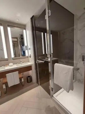 a bathroom with a shower and a sink and mirror at Luxury of 1 minute walk to Burj Khalifa & D/Opera in Dubai