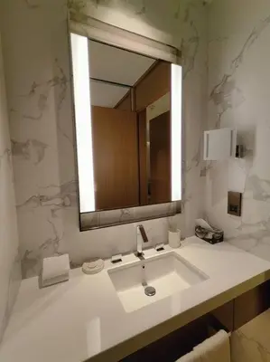 a white bathroom with a sink and a mirror at Luxury of 1 minute walk to Burj Khalifa & D/Opera in Dubai
