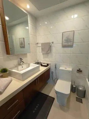 a bathroom with a sink and a toilet and a mirror at Waterfront Marina Best View Amazing Location 2 Bed in Dubai