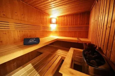 a wooden sauna with a bench in the middle at Waterfront Marina Best View Amazing Location 2 Bed in Dubai
