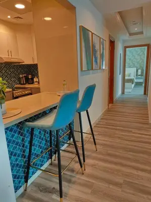 a kitchen with two chairs and a counter in a room at Waterfront Marina Best View Amazing Location 2 Bed in Dubai