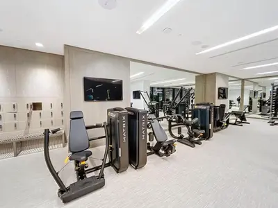 a gym with a row of treadmills and machines at Palace Residences - Modern One Bedroom in Dubai
