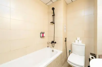 a bathroom with a tub and a toilet and a sink at Luxury Studio - Golf Views - Sports City Dubai in Dubai