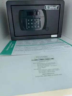 a microwave sitting on top of a table with a menu at Stay in brand new Luxury Sport City apartment 15 in Dubai