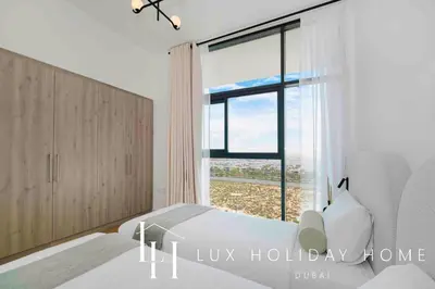 a bedroom with a bed and a large window at LUX The Dubai Hills Executive Suite in Dubai