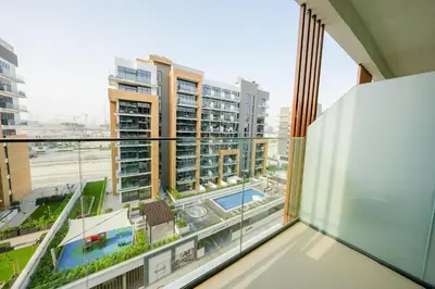 an apartment balcony with a view of a city at Azizi Riviera 18 in Dubai