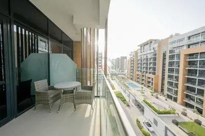 a balcony with a table and chairs and buildings at Azizi Riviera 18 in Dubai