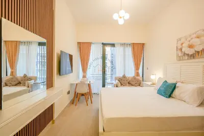 a bedroom with a bed and a living room at Azizi Riviera 18 in Dubai