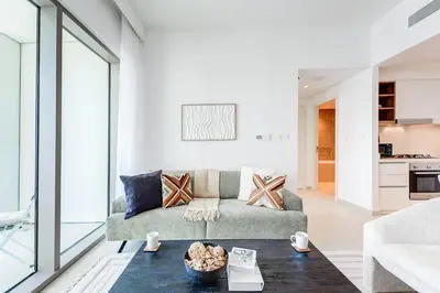 a living room with a couch and a table at Silkhaus High Floor 1 BDR In The Heart of Downtown in Dubai