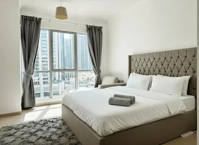 a bedroom with a large bed and a large window at The residences 1 - Luxury 1BR apt in Downtown Dubai - 2 mins walk to Burj Khalifa & Dubai Mall in Dubai