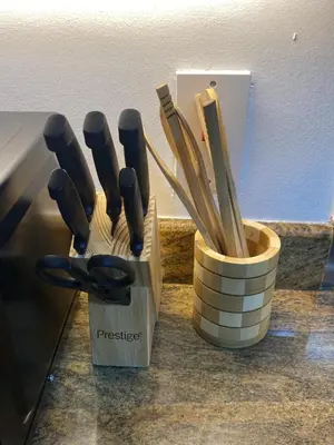 a container of wooden utensils sitting on a counter at The residences 1 - Luxury 1BR apt in Downtown Dubai - 2 mins walk to Burj Khalifa & Dubai Mall in Dubai