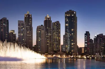 a water fountain in front of a city at night at The residences 1 - Luxury 1BR apt in Downtown Dubai - 2 mins walk to Burj Khalifa & Dubai Mall in Dubai
