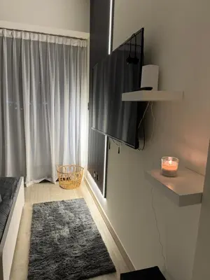 a living room with a couch and a window at Chic apartment, Maydan Riviera Dubaï in Dubai