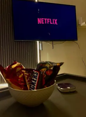a bowl of snacks on a table in front of a tv at Chic apartment, Maydan Riviera Dubaï in Dubai