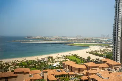 a view of a beach with buildings and the ocean at RH- Walk to JBR beach & Tram, Comfortable 02BR in Dubai