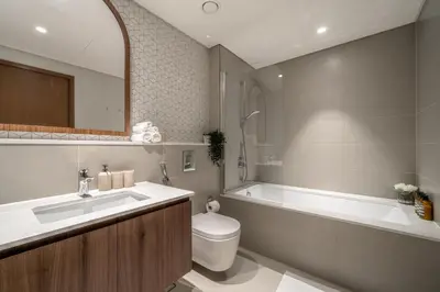 a bathroom with a sink and a toilet and a bath tub at Vida Voyage - Vida Residences - Creek Harbour in Dubai