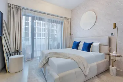 a bedroom with a large bed and a large window at Lux-Furnished Stu Couple-Friendly Near Downtown in Dubai