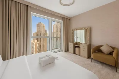 a bedroom with a large bed and a large window at La Vie, JBR, Dubai in Dubai