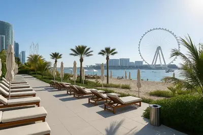 a row of lounge chairs and a ferris wheel at La Vie, JBR, Dubai in Dubai