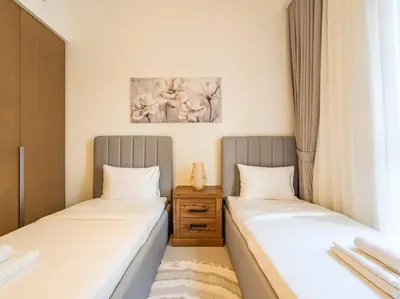 two beds sitting next to each other in a room at Ravishing Retreat 2BR Creek Beach Luxury Abode in Dubai