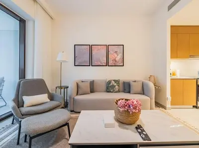 a living room with a couch and a chair at Ravishing Retreat 2BR Creek Beach Luxury Abode in Dubai
