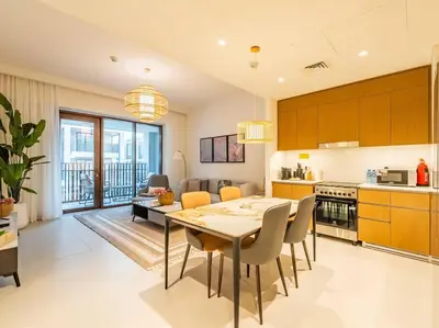 a kitchen and dining room with a table and chairs at Ravishing Retreat 2BR Creek Beach Luxury Abode in Dubai