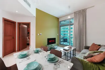 a living room with a couch and a table at Trophy - Magical Marina 1BDR connected to Metro Station in Dubai