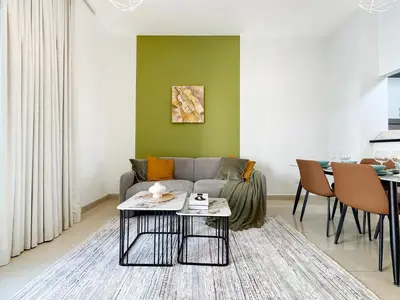 a living room with a couch and a table at Trophy - Magical Marina 1BDR connected to Metro Station in Dubai