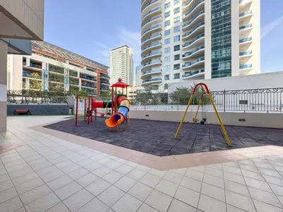 a playground in a city with tall buildings at Trophy - Magical Marina 1BDR connected to Metro Station in Dubai