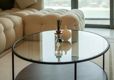 a glass coffee table in a living room with a couch at Waterfront ,High Floor 2BED with Private Beach Access in Dubai