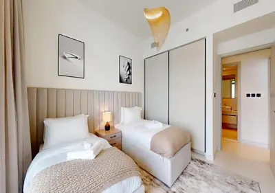 a bedroom with two beds and a mirror at Waterfront ,High Floor 2BED with Private Beach Access in Dubai
