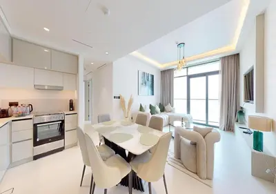 a kitchen and dining room with a table and chairs at Waterfront ,High Floor 2BED with Private Beach Access in Dubai