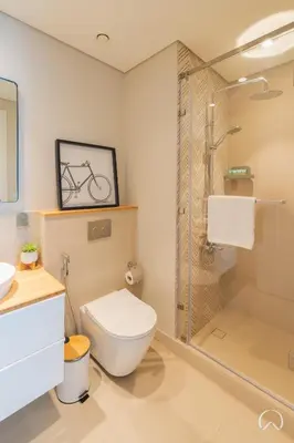 a bathroom with a shower and a toilet and a sink at Oraya - Collective 2 0 Tower A Sanctuary in Dubai Hills in Dubai