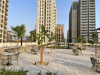 a patio with tables and chairs in a city at Oraya - Collective 2 0 Tower A Sanctuary in Dubai Hills in Dubai