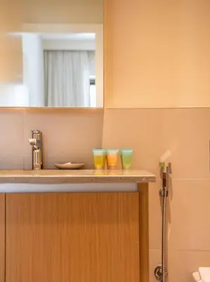 two glasses sitting on a counter in a bathroom at Serenity Cove: 1BR Luxury Beach Retreat in Dubai